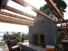 Cedar arbor over outdoor fireplace - West Seattle, Ecoyards.