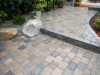 Roman cobblestone paver patio with boulder seating - West Seattle, Ecoyards.