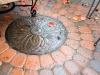NW manhole feature in circular paver