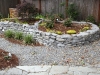 Raised landscape bed with new plantings