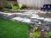 Dry stack wall with steps, new sod, patio, and landscape lighting - Seattle, Ecoyards.